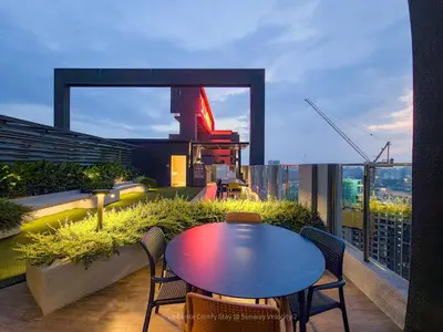 a table and chairs on top of a balcony at 3BR Sunway Velocity 2 TRX KLCC in Kuala Lumpur