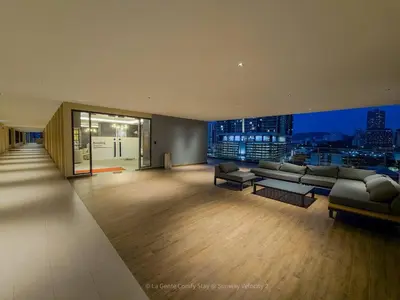 a living room with couches and a view of a city at 3BR Sunway Velocity 2 TRX KLCC in Kuala Lumpur
