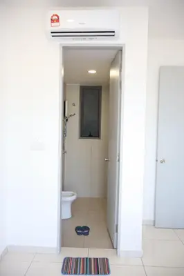 a white bathroom with a toilet and a window at COZY KenwingstonThe platz Trail 3BR&2BR For 8PAX wifi free Parkin nice view 1902 in Kuala Lumpur