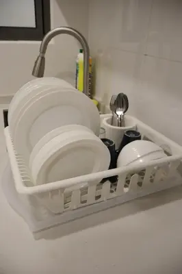 a dish drying rack with plates and utensils at COZY KenwingstonThe platz Trail 3BR&2BR For 8PAX wifi free Parkin nice view 1902 in Kuala Lumpur