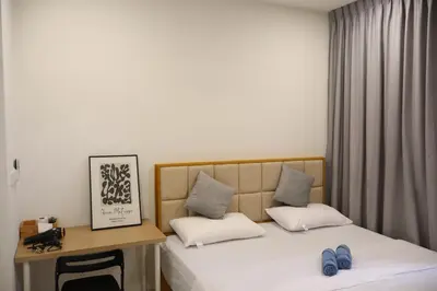a bedroom with a bed and a desk with blue shoes at COZY KenwingstonThe platz Trail 3BR&2BR For 8PAX wifi free Parkin nice view 1902 in Kuala Lumpur