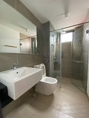 a bathroom with a sink and a toilet and a shower at La Gente Comfy Stay 2R2B Velocity - KL City View in Kuala Lumpur