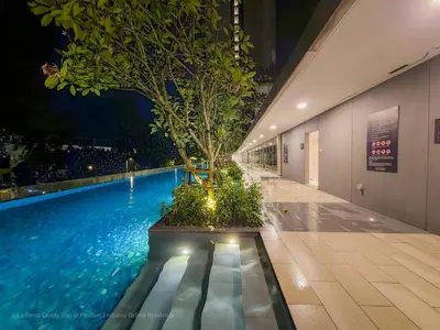 a swimming pool with a tree in the middle of a building at 4R3B Luxe KLCC Embassy Pavilion 600MBPS Gas cook in Kuala Lumpur