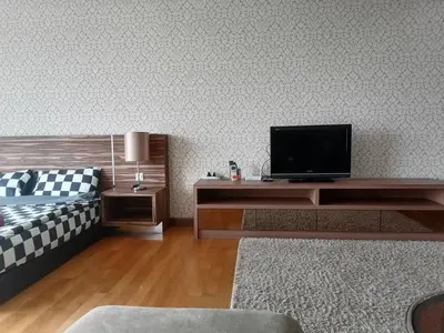 a living room with a tv and a couch at REGALIA RESIDENCE KLCC VIEW INFINITY POOL by BT RZQNA in Kuala Lumpur