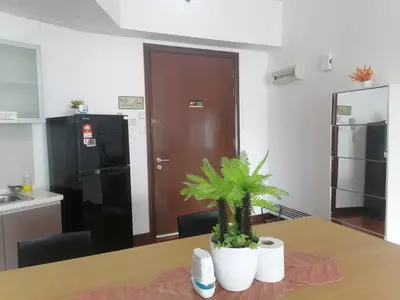 a kitchen with a table with two potted plants on it at REGALIA RESIDENCE KLCC VIEW INFINITY POOL by BT RZQNA in Kuala Lumpur