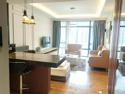 a living room with a kitchen and a living room with a table at Anggun Residence by Harmony Home in Kuala Lumpur
