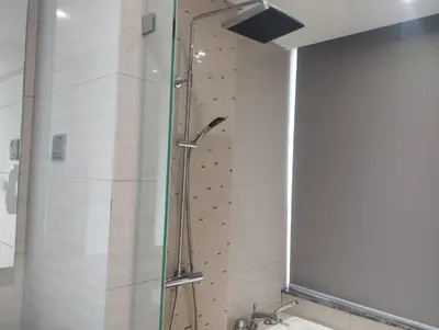 a shower with a glass door in a bathroom at Anggun Residence by Harmony Home in Kuala Lumpur