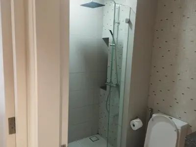 a bathroom with a toilet and a glass shower at Anggun Residence by Harmony Home in Kuala Lumpur