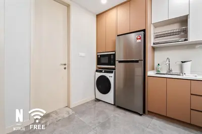 a kitchen with a refrigerator and a washing machine at OOAK 2BR - Mont Kiara Garden international school in Kuala Lumpur