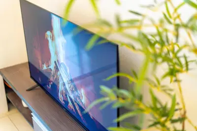a flat screen tv sitting on a table with plants at Carlton, Chelsea by COBNB, Sri Hartamas, Kuala Lumpur in Kuala Lumpur