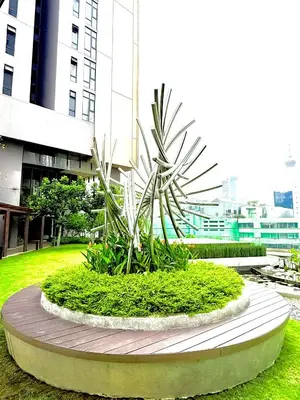 a plant in a circle in front of a building at LUXURY AXON SUITES KLCC PAVILION At BUKIT BINTANG in Kuala Lumpur
