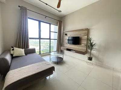 a bedroom with a bed and a tv and a window at Weekend House Trion in Kuala Lumpur