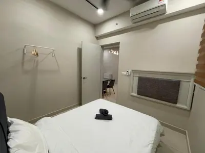 a room with a bed with a black teddy bear on it at Weekend House Trion in Kuala Lumpur