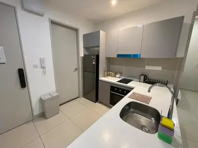 a small kitchen with a sink and a refrigerator at Weekend House Trion in Kuala Lumpur