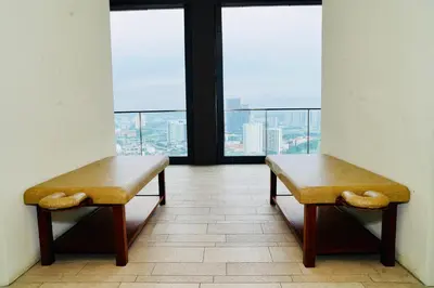 two benches in a room with views of a city at Luxury Suites Lucentia Residence KLCC at BBCC in Kuala Lumpur