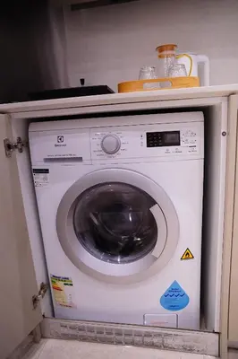 a white washing machine sitting in a kitchen at Luxury Suites Lucentia Residence KLCC at BBCC in Kuala Lumpur