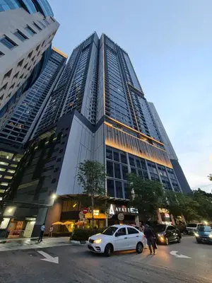 a tall building with cars parked in front of it at Agile Residensi Service Apartment Kuala lumpur in Kuala Lumpur