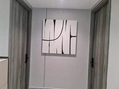 a painting hanging on a wall next to two windows at Agile Residensi Service Apartment Kuala lumpur in Kuala Lumpur