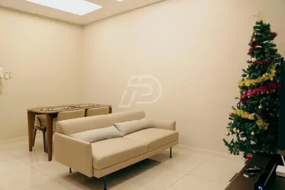 a living room with a christmas tree and a couch at Dorsett Hartamas KL, Bathtub Smart TV & WiFi in Kuala Lumpur