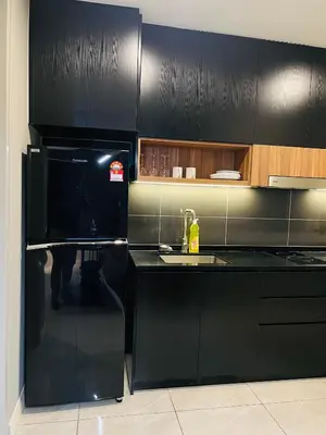 a black kitchen with a sink and a microwave at Axon Suites Bukit Bintang near KLCC by Unitopia in Kuala Lumpur