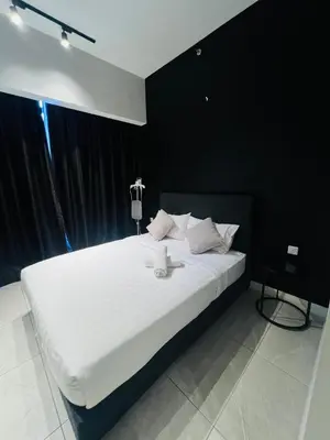 a bedroom with a large white bed with black walls at Axon Suites Bukit Bintang near KLCC by Unitopia in Kuala Lumpur