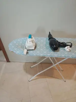 a glass table with a iron and a telephone on it at Vortex suites klcc by yana in Kuala Lumpur