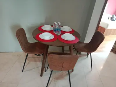 a dining room table with red plates and chairs at Vortex suites klcc by yana in Kuala Lumpur