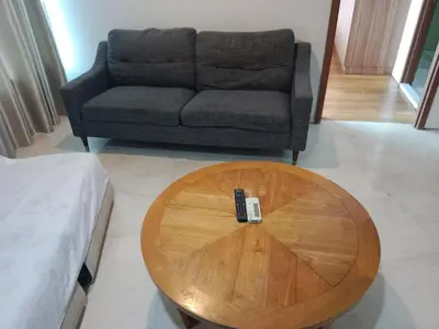 a wooden coffee table in a living room with a couch at Vortex suites klcc by yana in Kuala Lumpur
