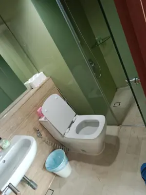 a bathroom with a toilet and a sink and a shower at Vortex suites klcc by yana in Kuala Lumpur