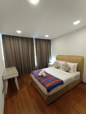 a bedroom with a bed with a teddy bear on it at KLCC Sky Villa Suites Vortex in Kuala Lumpur