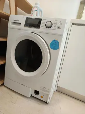 a washing machine with a bottle on top of it at KLCC Sky Villa Suites Vortex in Kuala Lumpur