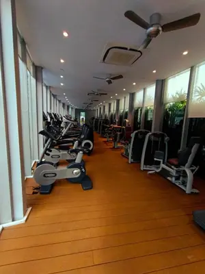 a gym with a row of treadms and machines at KLCC Sky Villa Suites Vortex in Kuala Lumpur