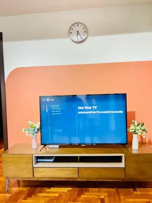 a large flat screen tv sitting on top of a table at KLCC Sky Villa Suites The Mews in Kuala Lumpur
