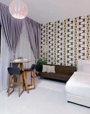 a bedroom with a bed and a table and a bed and a table and chairs at Regalia Suites Kuala Lumpur by Cozyvista Suites in Kuala Lumpur