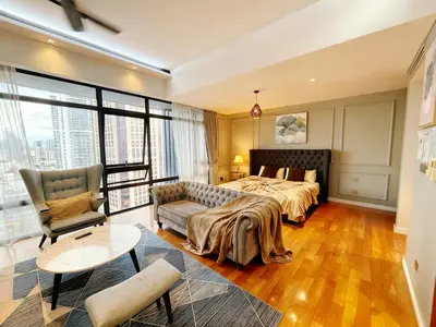 a large bedroom with a bed and a couch at KLCC Bukit Bintang Anggun Residence 5min walk to Monorail station in Kuala Lumpur