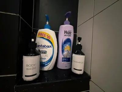 a group of four cleaning products sitting on a shelf at KLCC Bukit Bintang Anggun Residence 5min walk to Monorail station in Kuala Lumpur