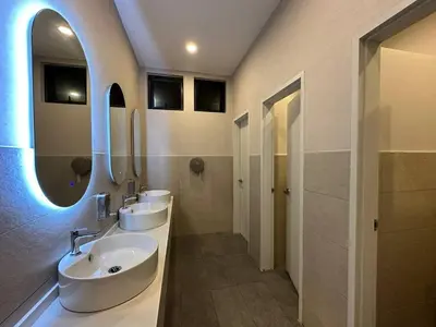 a bathroom with two sinks and two mirrors at Majestic Residence KLCC By Flixhome in Kuala Lumpur