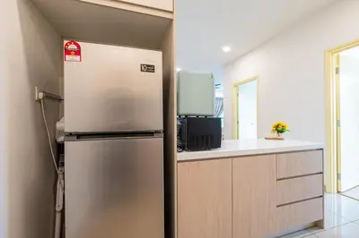 a kitchen with a stainless steel refrigerator and a counter at Blossom Playground with kids friendly home Arte Plus in Kuala Lumpur