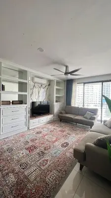 a living room with a couch and a flat screen tv at AF Guesthouse Kampung Baru, KL in Kuala Lumpur