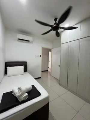 a bedroom with a bed with a ceiling fan at AF Guesthouse Kampung Baru, KL in Kuala Lumpur