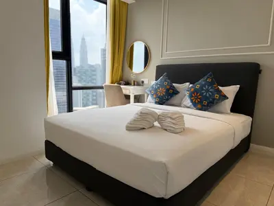 a bedroom with a large bed with a large window at Axon Residensi Bukit Bintang in Kuala Lumpur