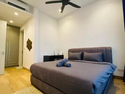 a bedroom with a bed with a blue stuffed animal on it at Lucentia Residences Bukit Bintang KLCC By LUZBNB in Kuala Lumpur