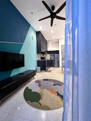 a living room with a ceiling fan and a kitchen at Lucentia Residences Bukit Bintang KLCC By LUZBNB in Kuala Lumpur