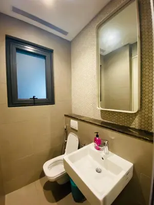a bathroom with a sink and a toilet and a mirror at Lucentia Residences Bukit Bintang KLCC By LUZBNB in Kuala Lumpur