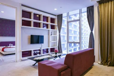 a living room with a couch and a tv at The Platinum KLCC By Aura Suites in Kuala Lumpur