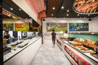 a man standing in front of a bakery at The Platinum KLCC By Aura Suites in Kuala Lumpur