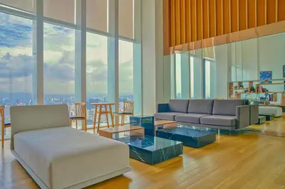 a living room with a couch and a table at The Platinum KLCC By Aura Suites in Kuala Lumpur