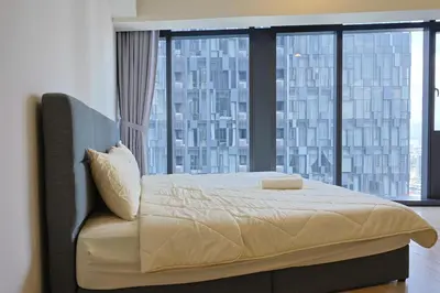 a bedroom with a bed with a large window at Star Residences By Minos Homestay in Kuala Lumpur