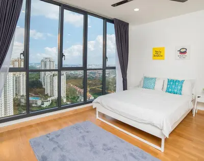 a bedroom with a white bed and large windows at Karaoke Party Penthouse at KL Gateway by Cobnb in Kuala Lumpur
