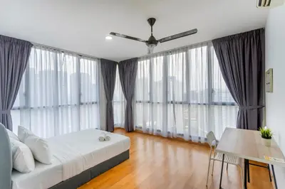a bedroom with a bed and large windows at Karaoke Party Penthouse at KL Gateway by Cobnb in Kuala Lumpur